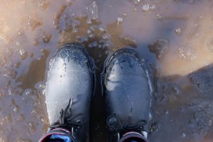 rubber boots in a puddle