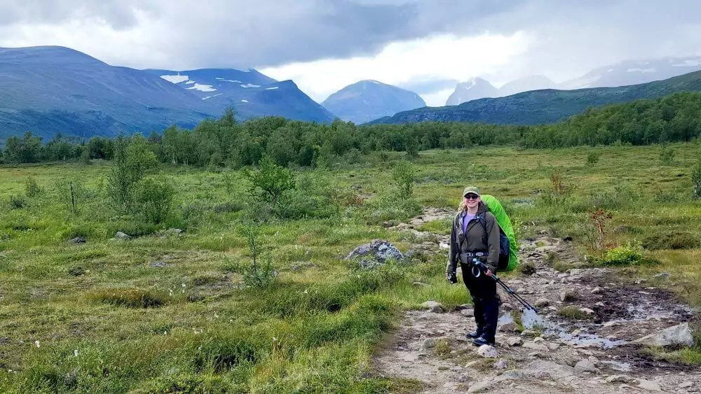 Sarah ready to keep hiking with mountains in the distance