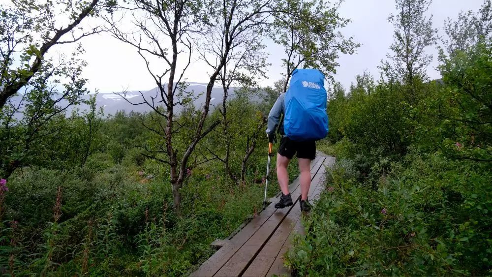 Paul walking along a board walk