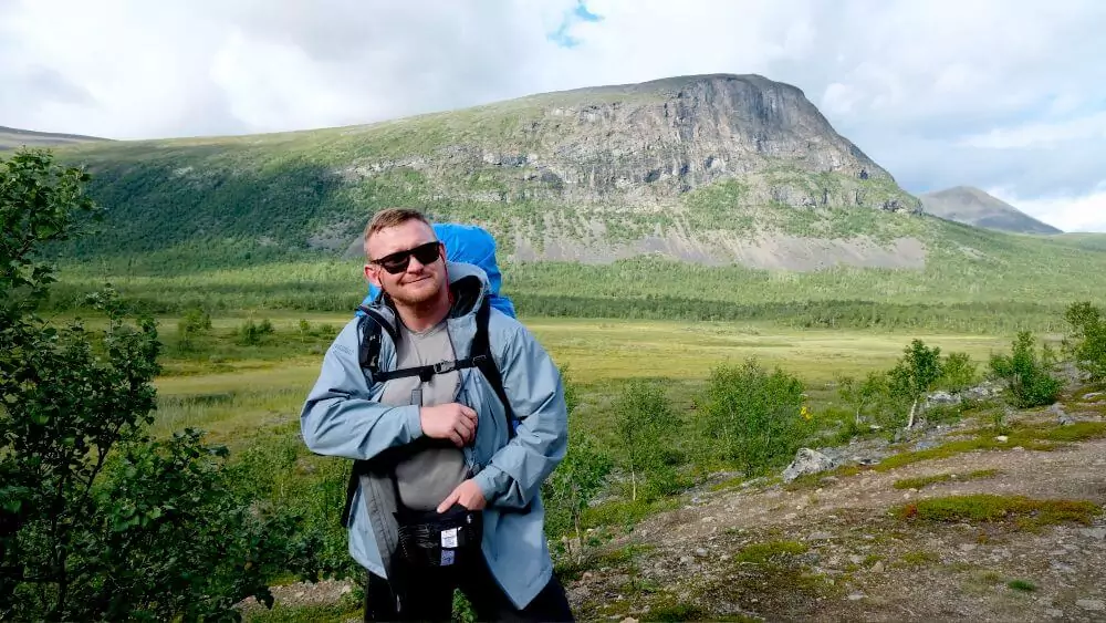 Paul standing in front of a mountain